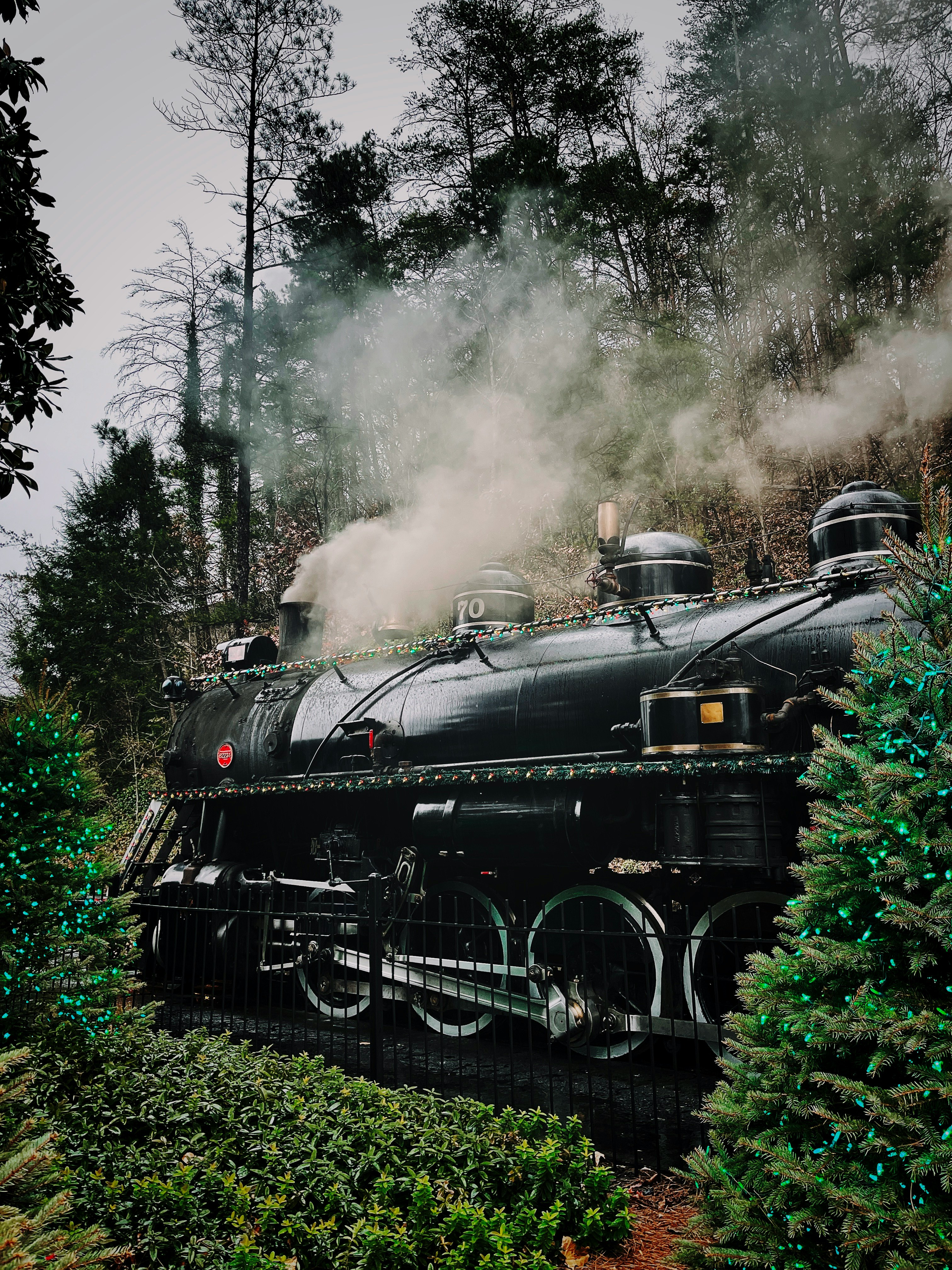 black train on rail tracks during daytime